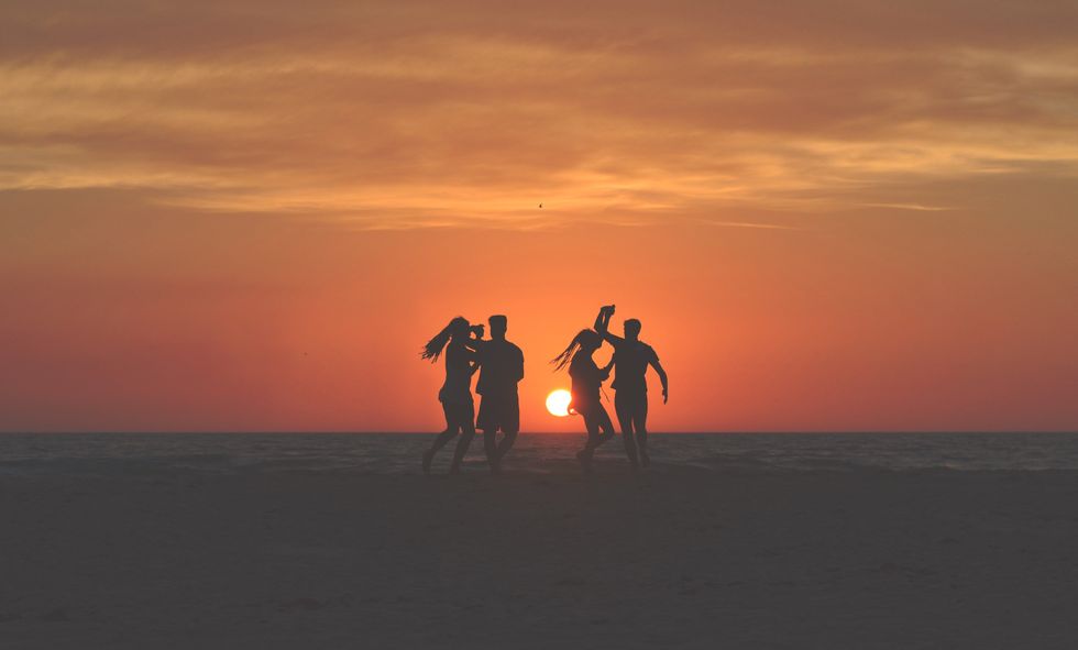 friends dancing on the beach