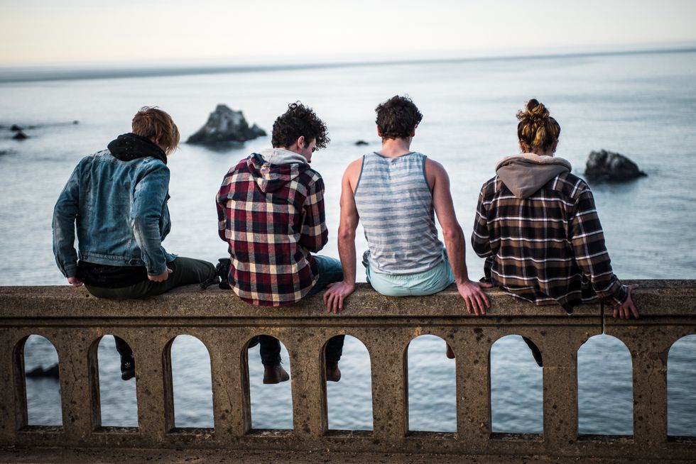 friends sitting on a ledge