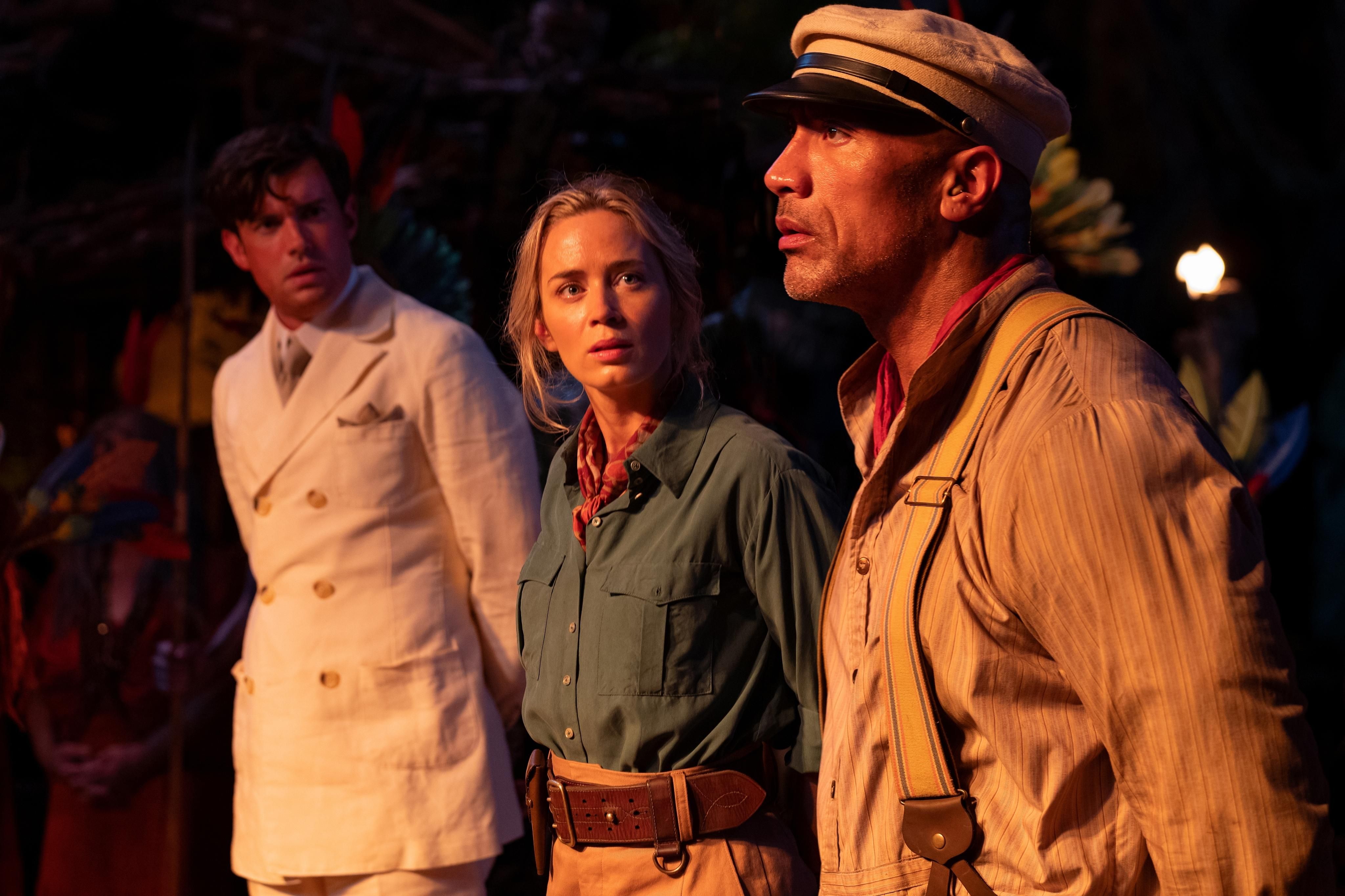 From Left to Right: Macgregor (played by Jack Whitehall), Lily (played by Emily Blunt) and Frank (played by Dwayne Johnson) are standing side by side in a movie still from Disney's "Jungle Cruise."