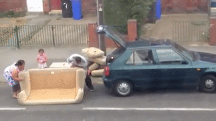 Giph with people putting their sofa on the truck of the car. 