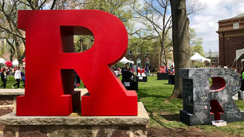 Girl biting a pencil and staring at her laptop
