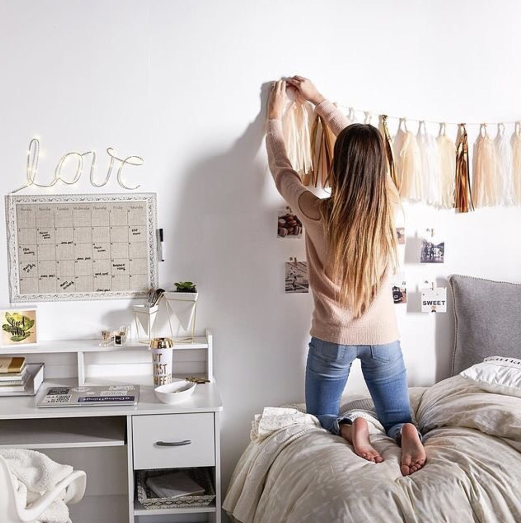 girl decorating wall in her room