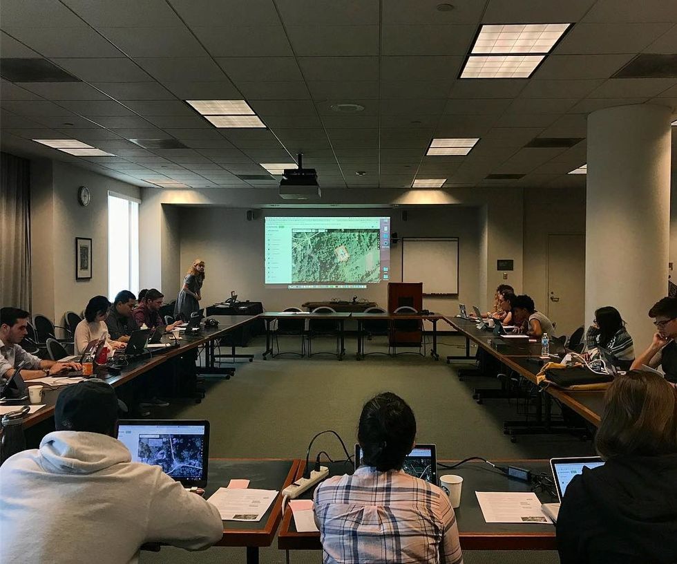 Girl holding her backback and books