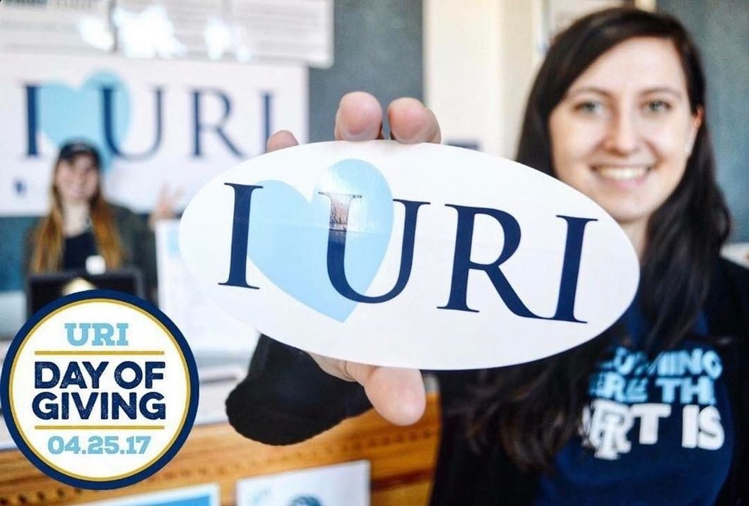 girl holding uri sticker