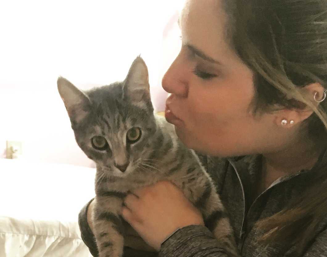 girl kissing cat