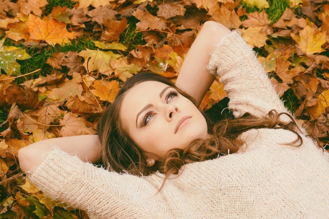 girl laying in leaves