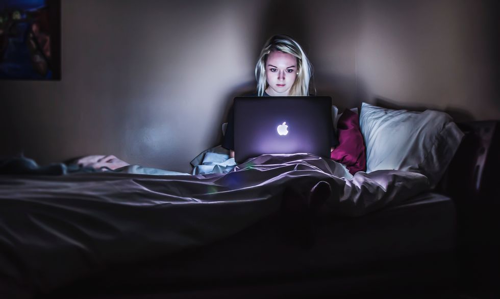 girl on computer in the dark