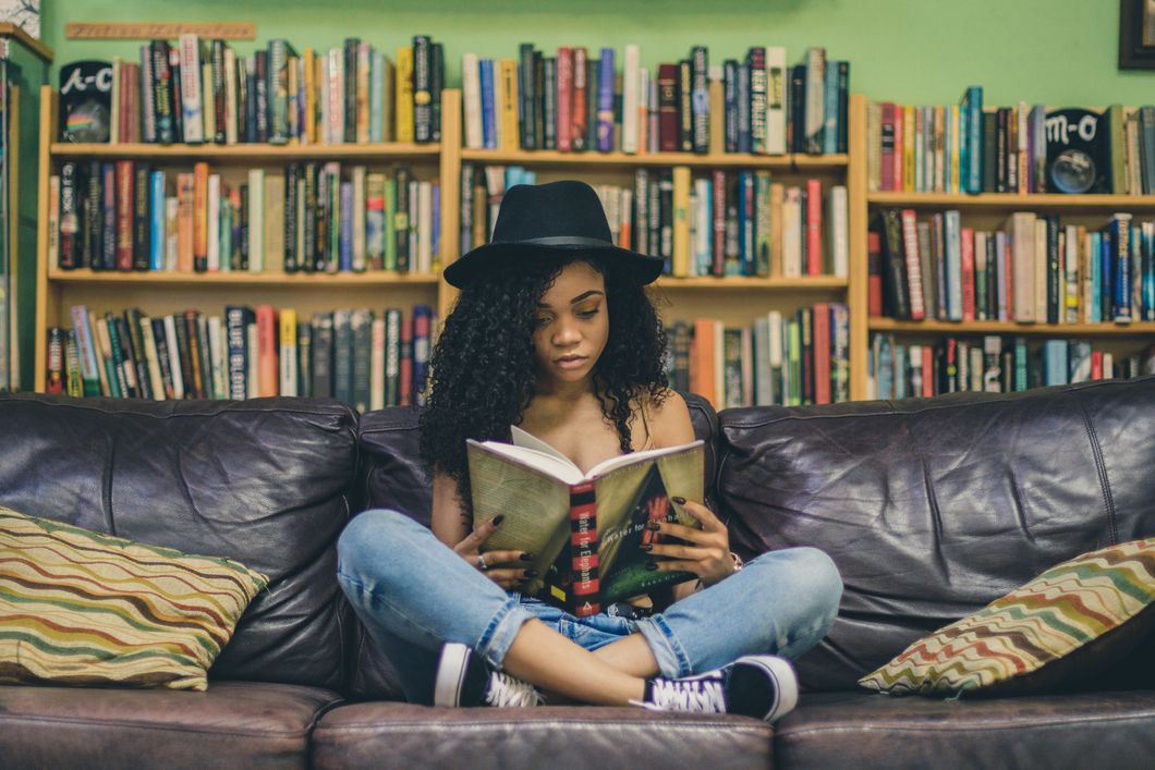 Girl reading a book on a couch