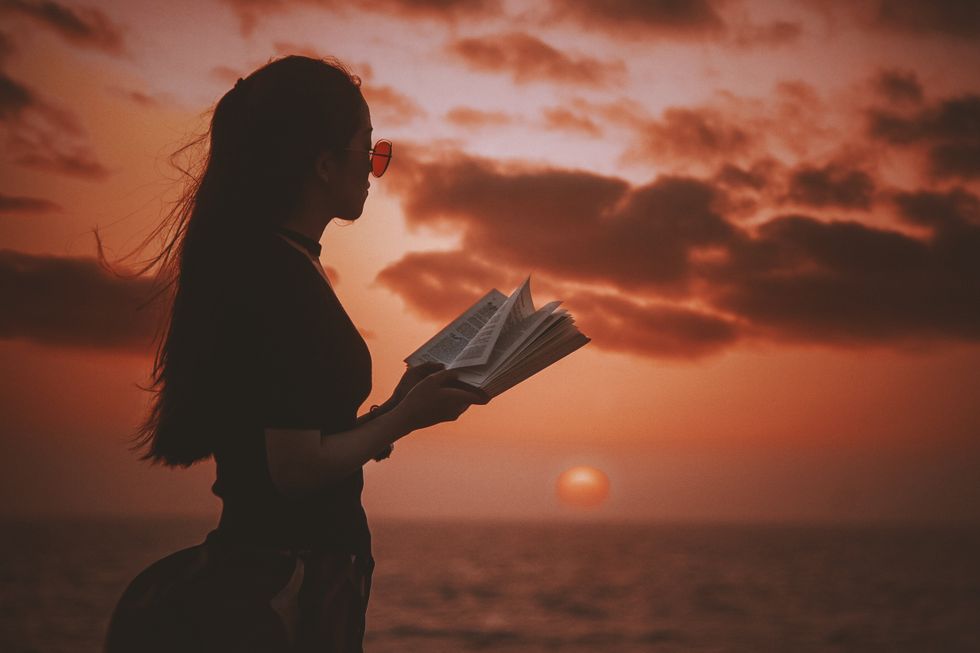 girl reading and a sunset