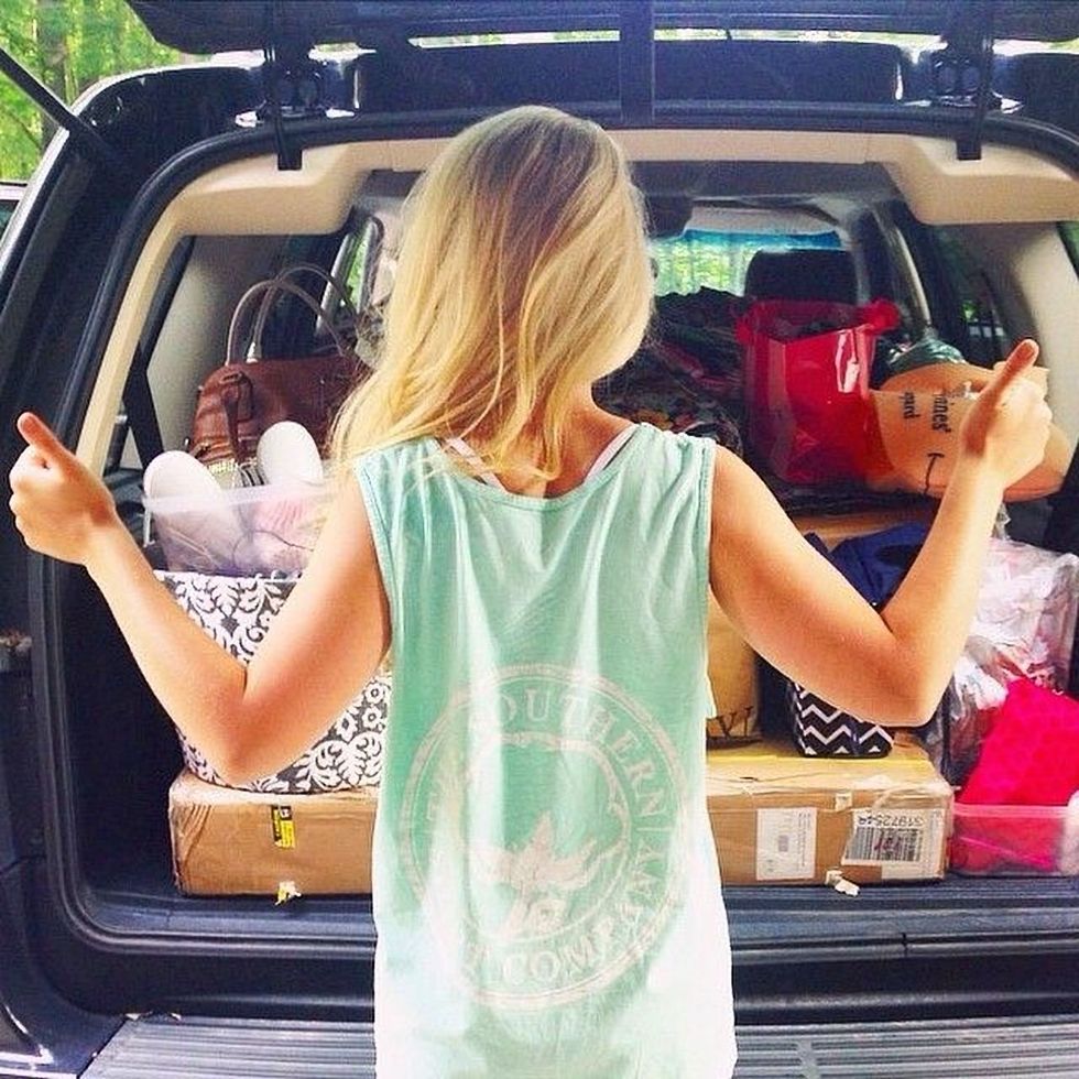 Girl ready to go with her move in the back of her car.