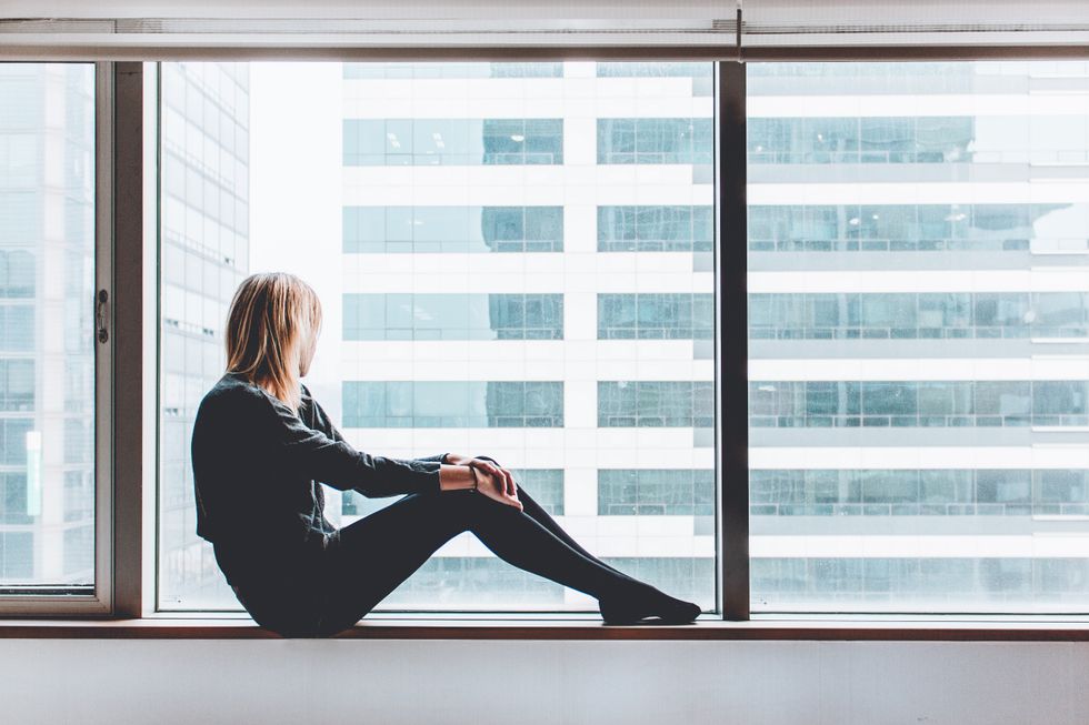 Girl sitting and looking out of window