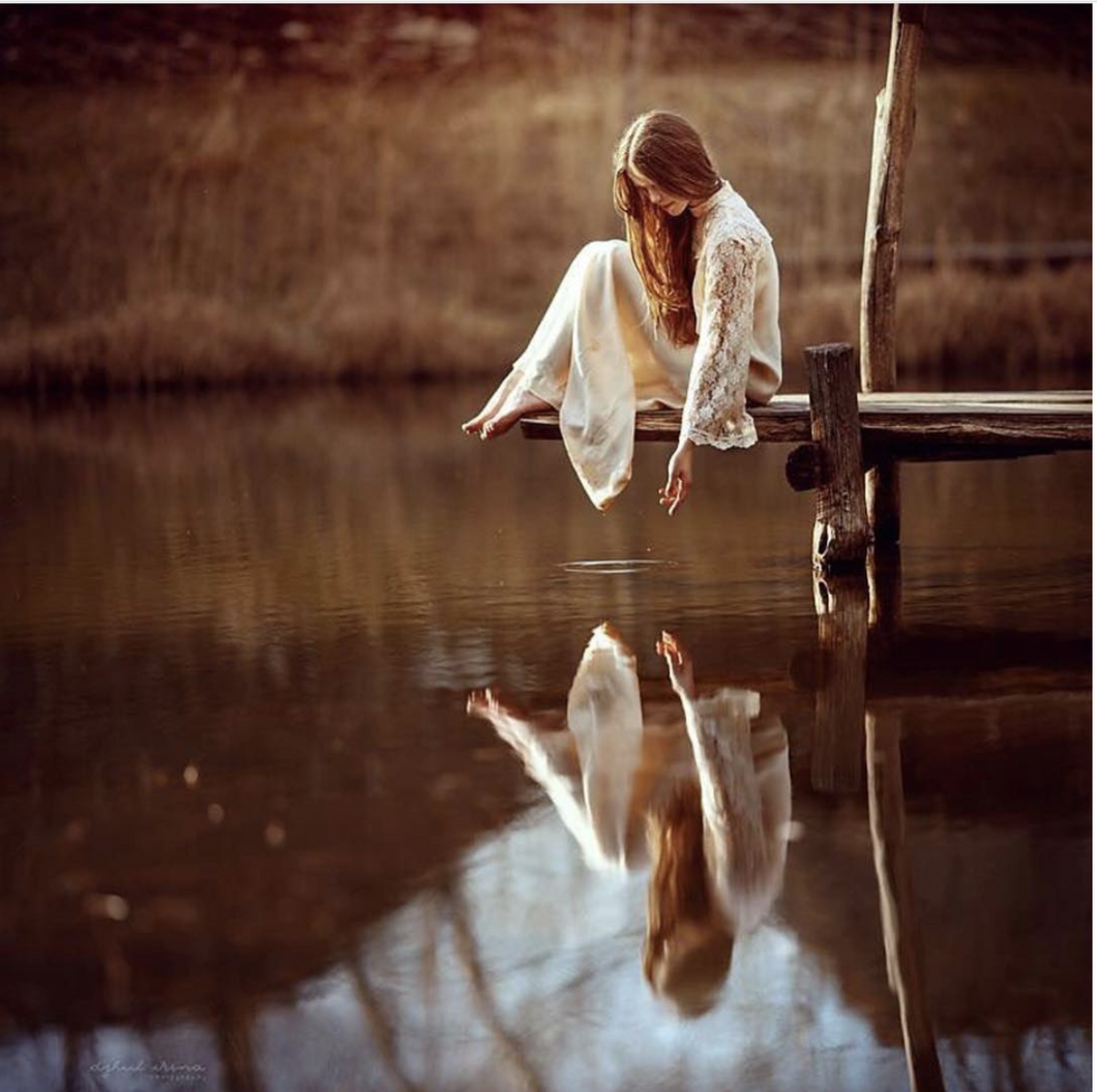 girl sitting by water
