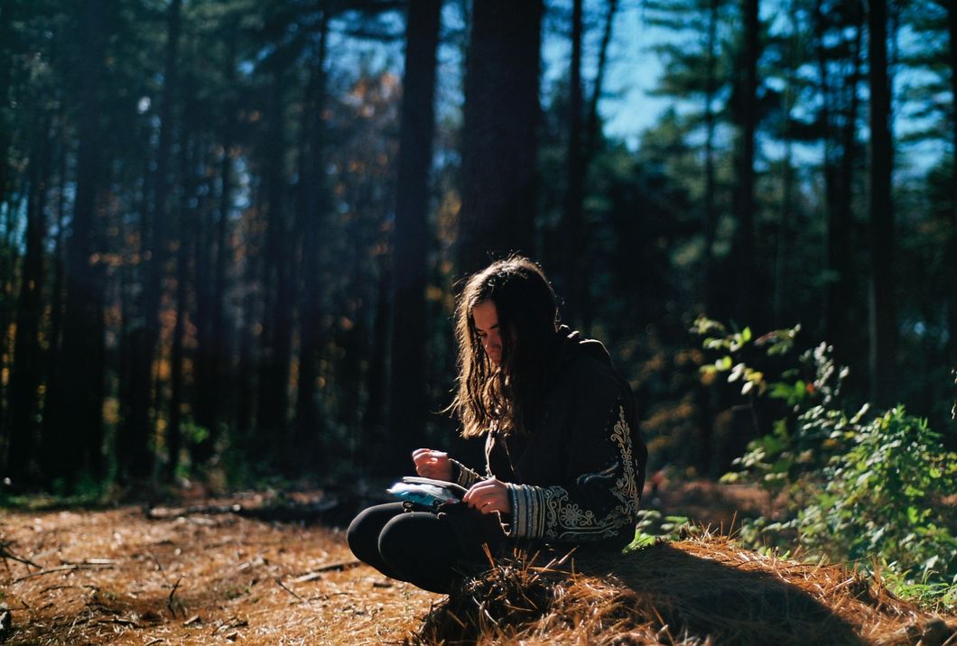 Girl sitting in a forest
