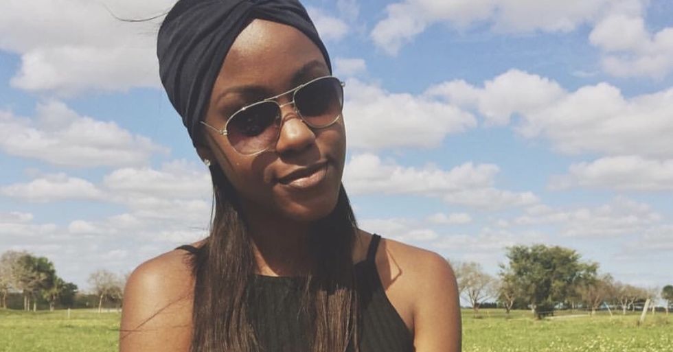 girl sitting in field
