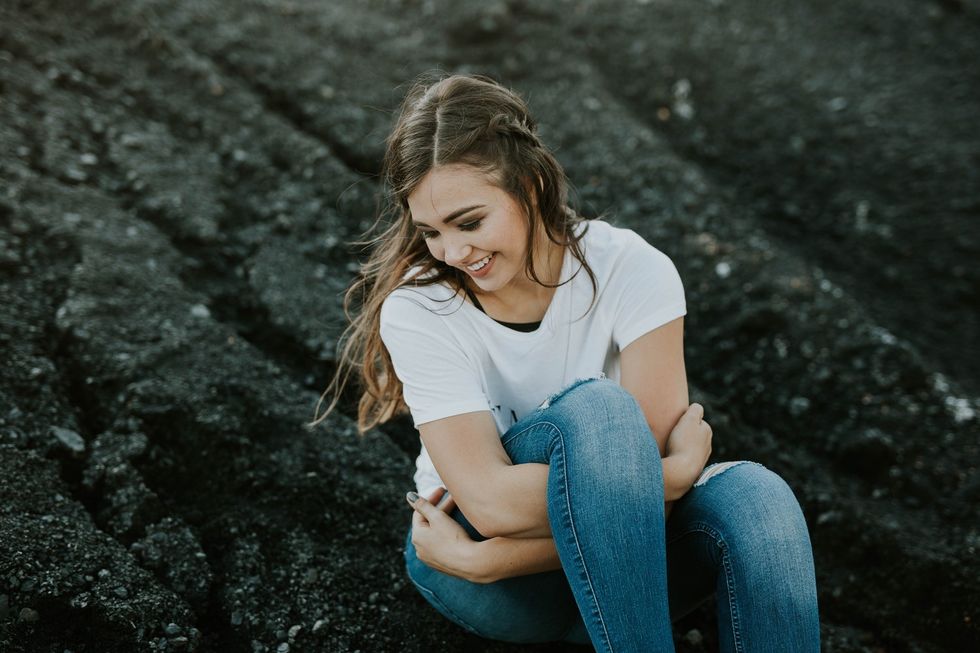 girl sitting on rock