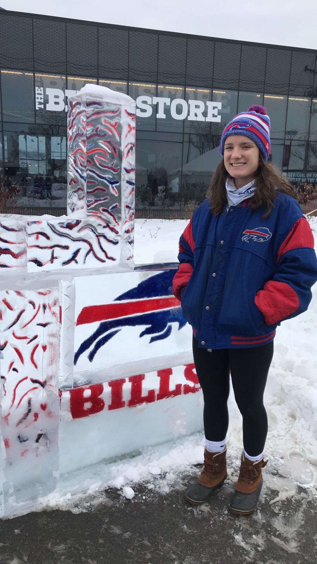 girl standing outside buffalo bills store in the snow