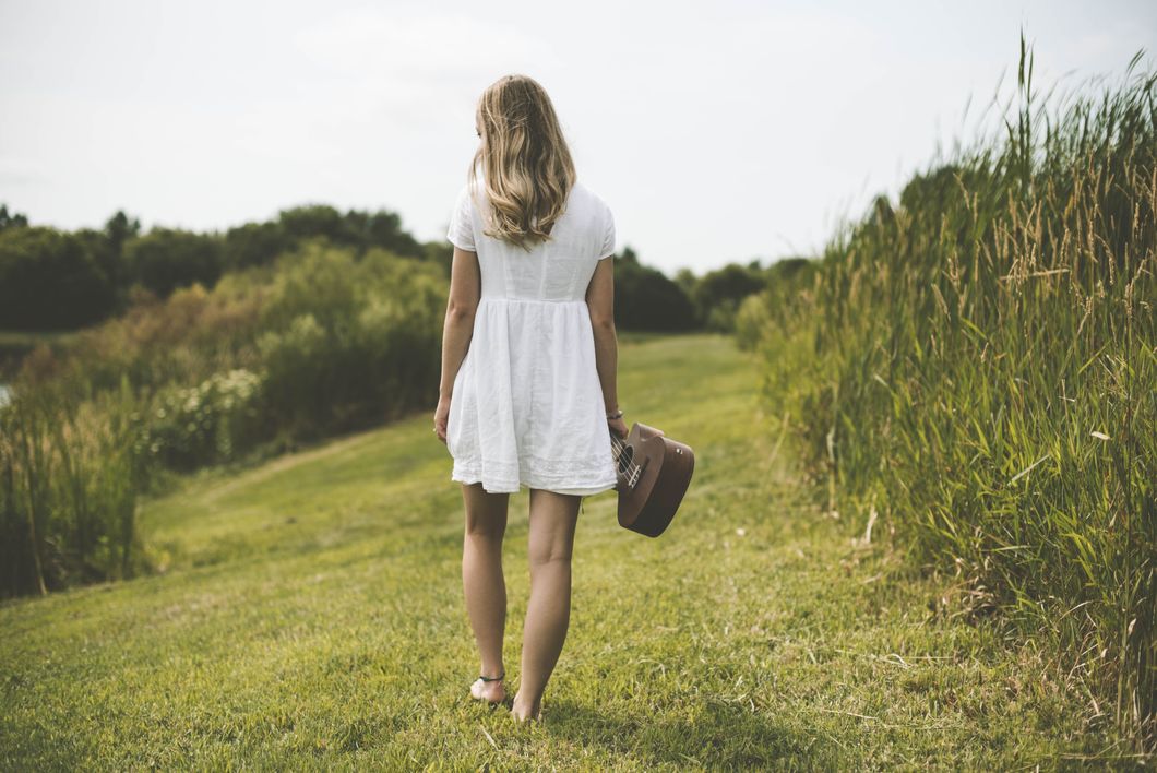 Girl walking through a meadow