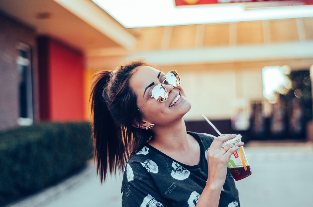 Girl wearing glasses and drinking coffee