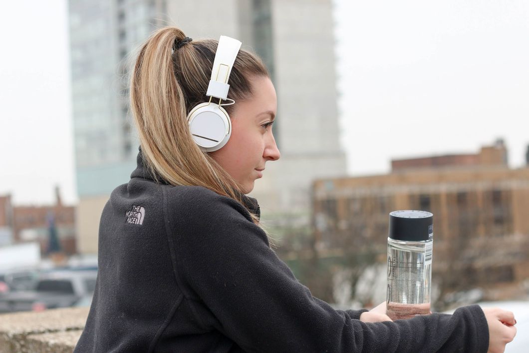 Girl wearing headphones and looking out into the distance