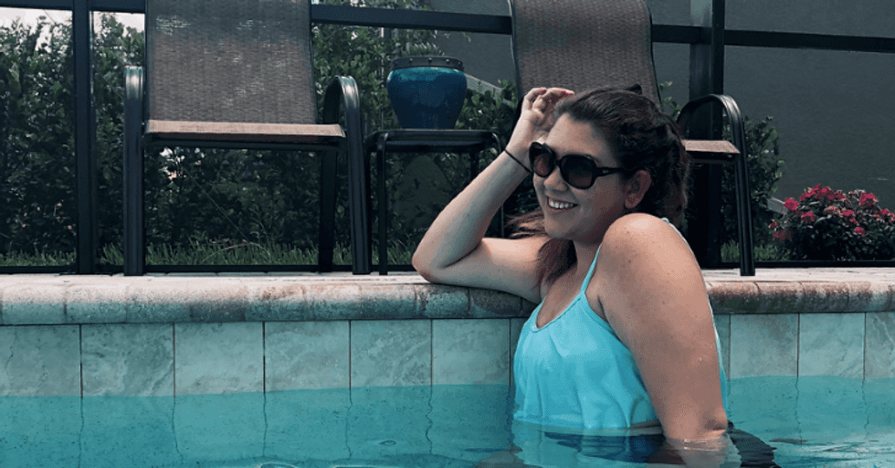 girl wearing sunglasses swimming in pool