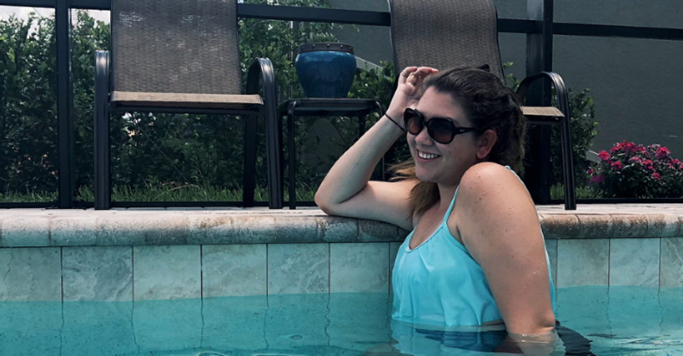 girl wearing sunglasses swimming in pool