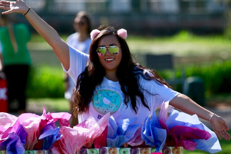 Girl with her hands in the air.