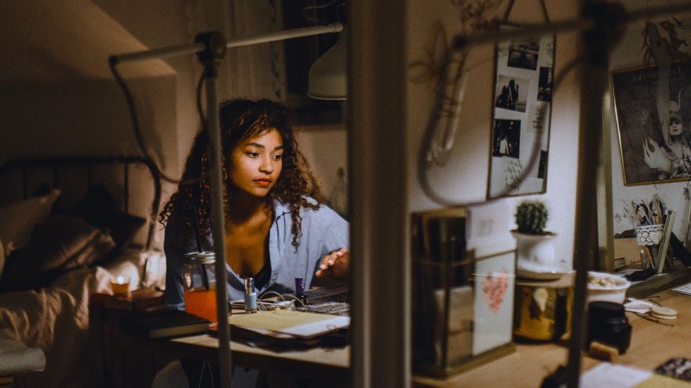 Girls gathered around a bonfire