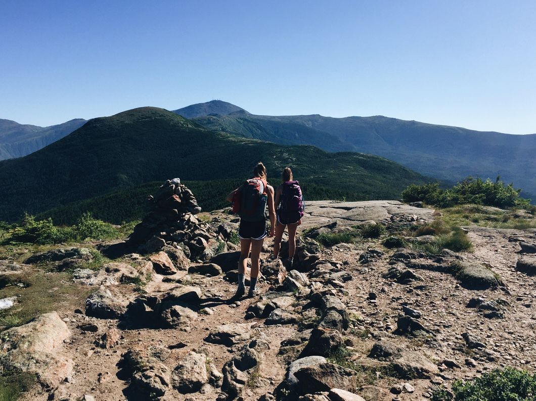 girls hiking across mountain