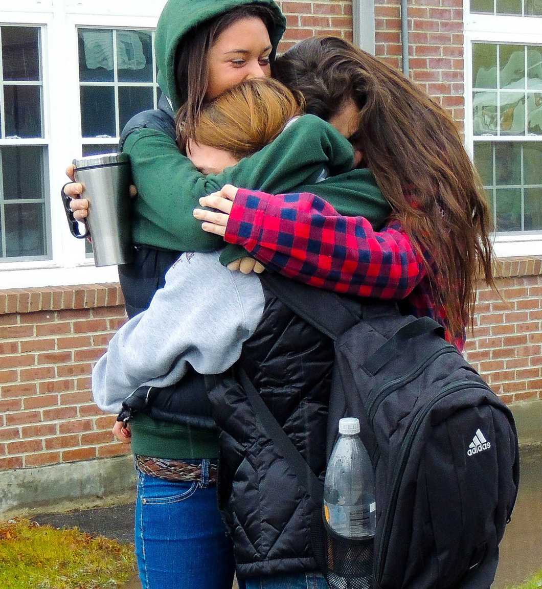 girls hugging each other