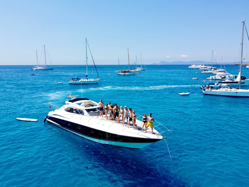 Group of people standing on a boat in the ocean