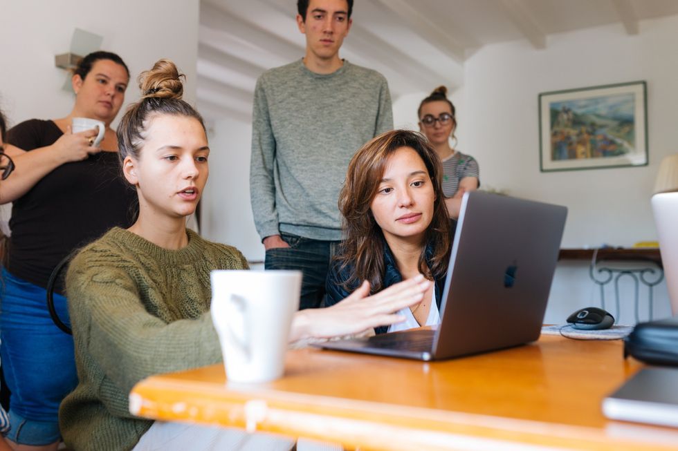 Group of students around a computer