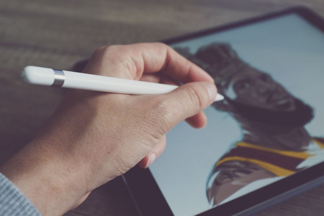 Guy drawing on a tablet