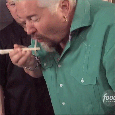 Guy Fieri eating a noodle