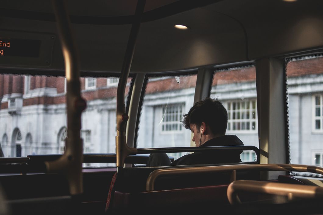 Guy sitting alone on a bus