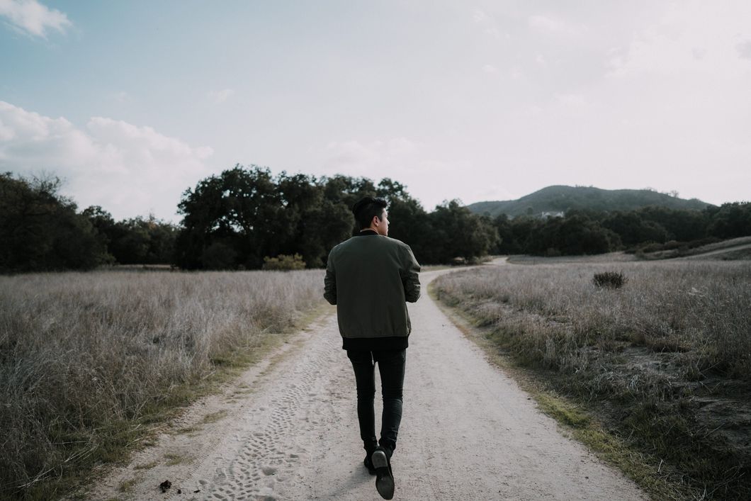 Guy walking down an empty road
