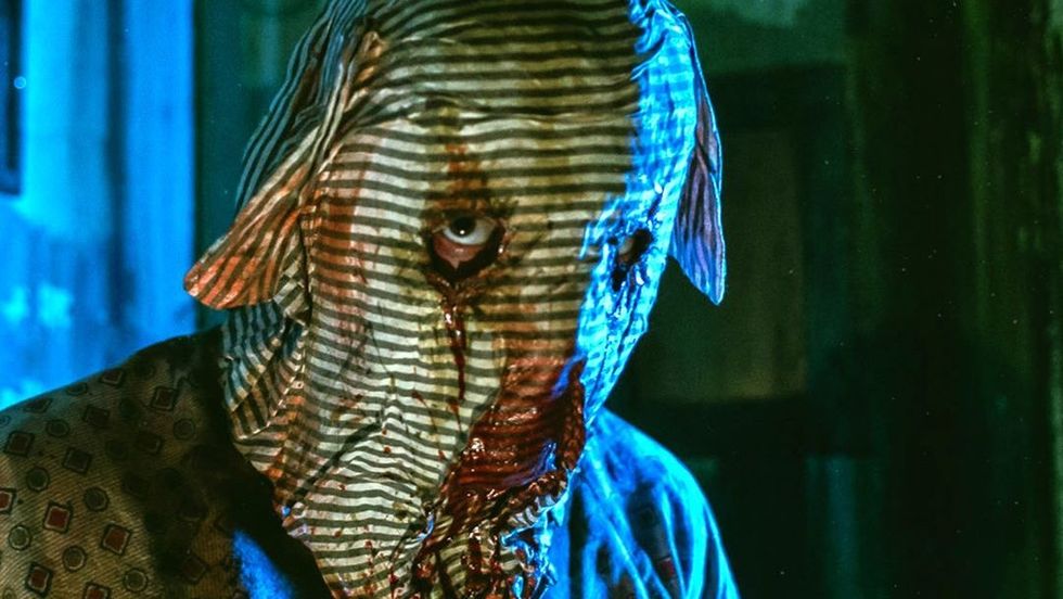 Guy wearing a scary Halloween mask