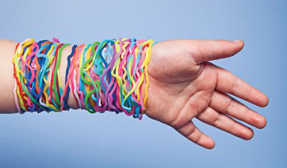 Hand and arm wearing lots of silly bandz