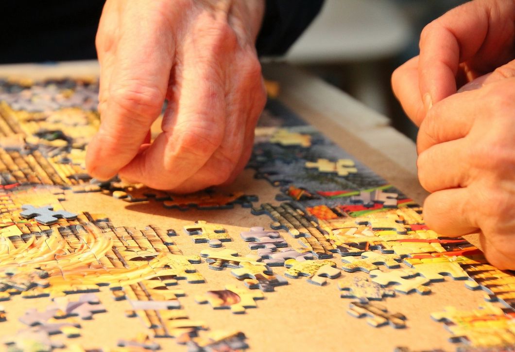 hands doing a puzzle