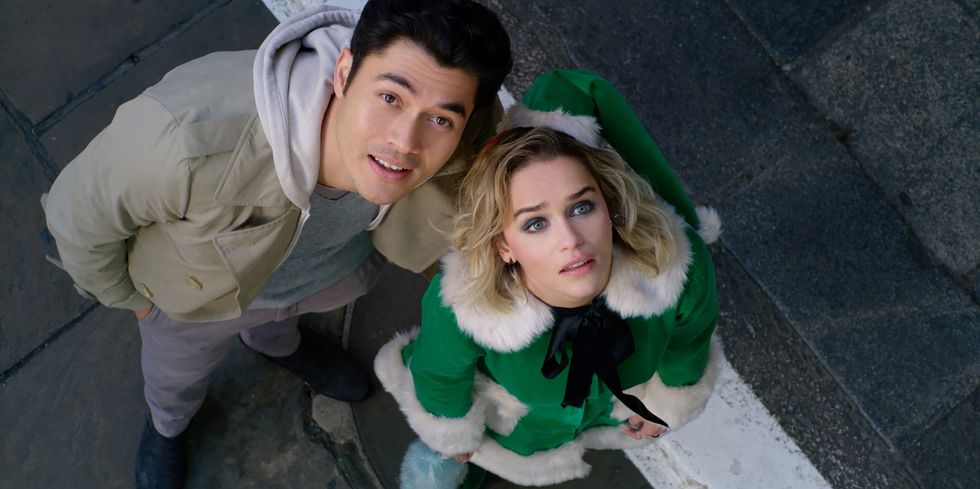 Henry Golding and Emilia Clarke are looking up at the camera in "Last Christmas."
