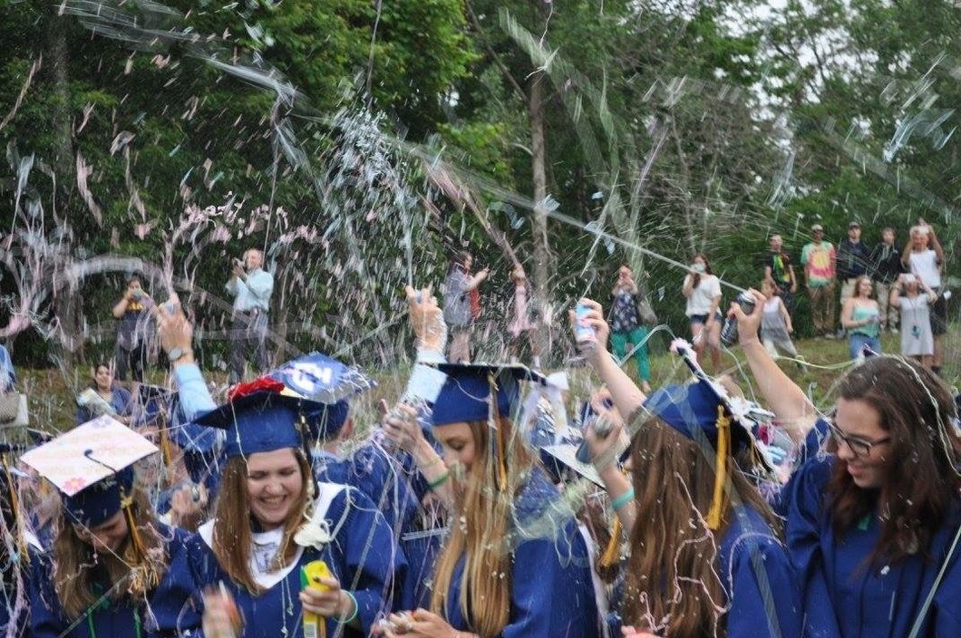 high school graduation girls spraying silly string