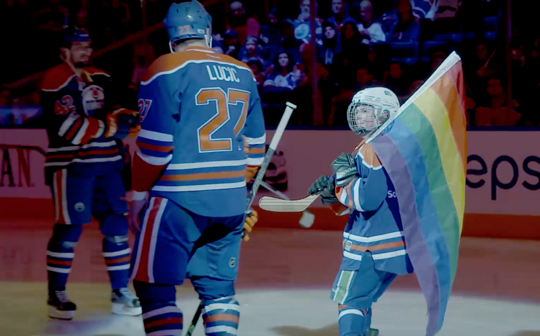 hockey players holding gay pride flag
