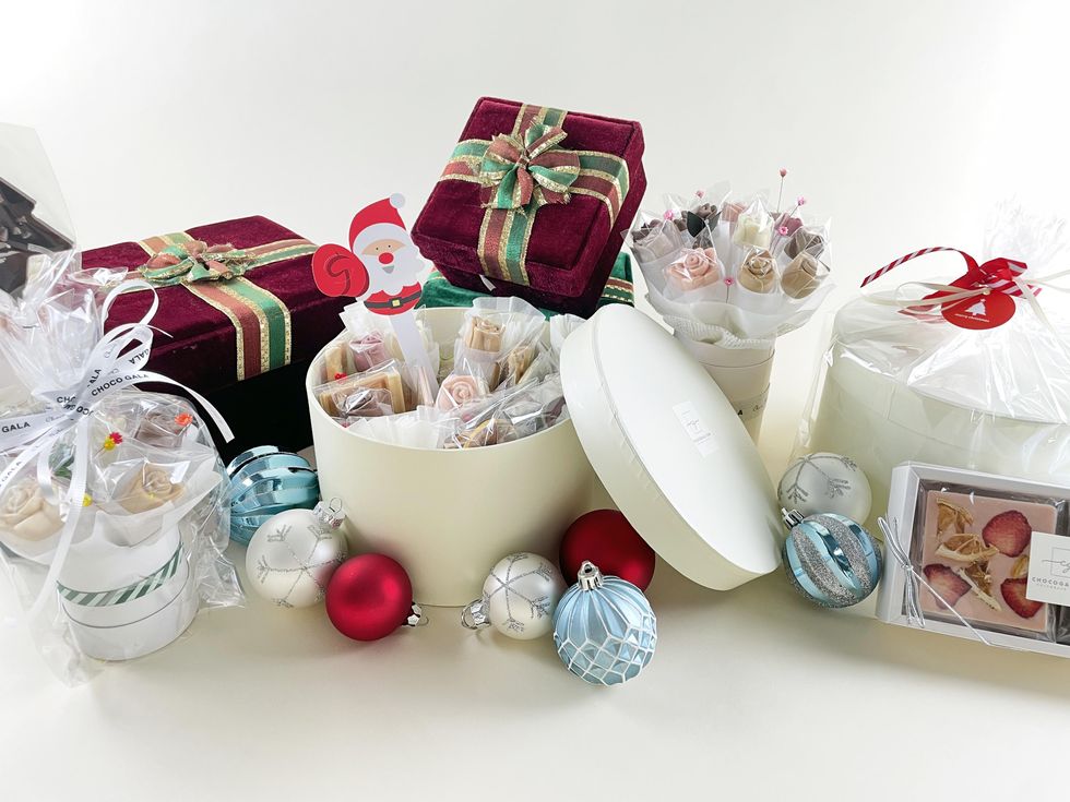 holiday gifts wrapped in bows with ornaments
