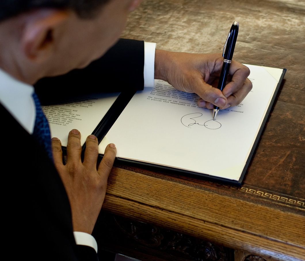 https://commons.wikimedia.org/wiki/File:Barack_Obama_signs_at_his_desk2.jpg