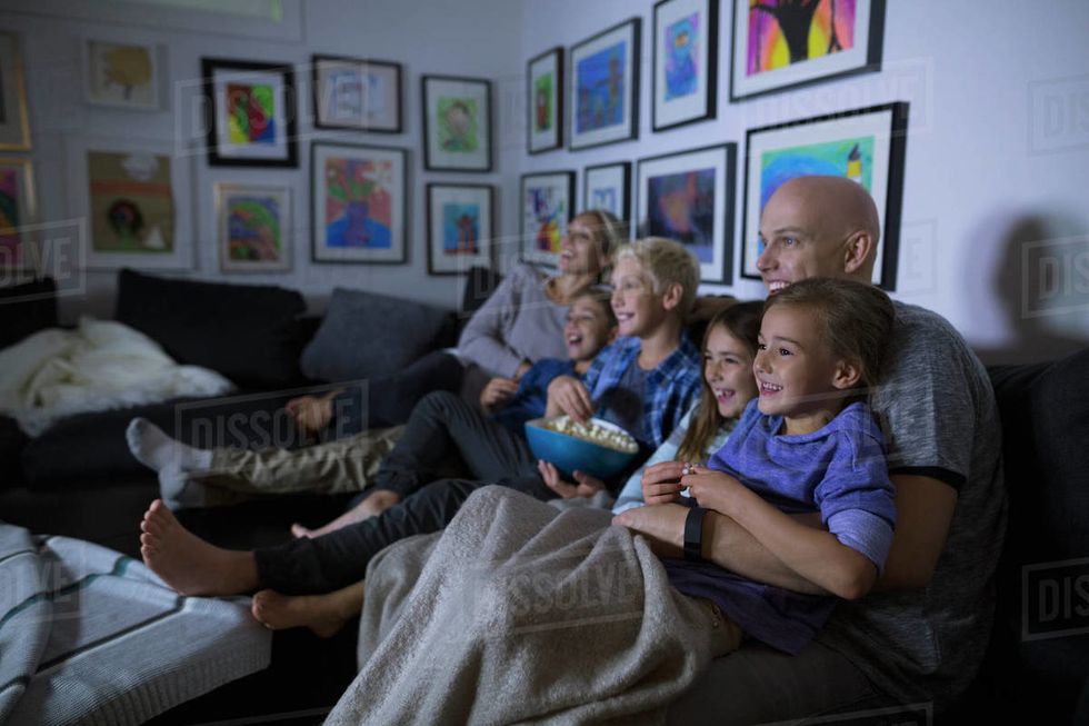 https://dissolve.com/stock-photo/Family-eating-popcorn-watching-movie-dark-living-royalty-free-image/101-D237-77-158