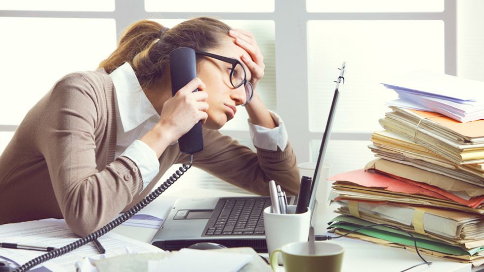 https://showandtellonline.com.au/relationships/four-day-working-week/attachment/a-stressed-business-woman-looks-tired-she-answer-telephones-in-her-office
