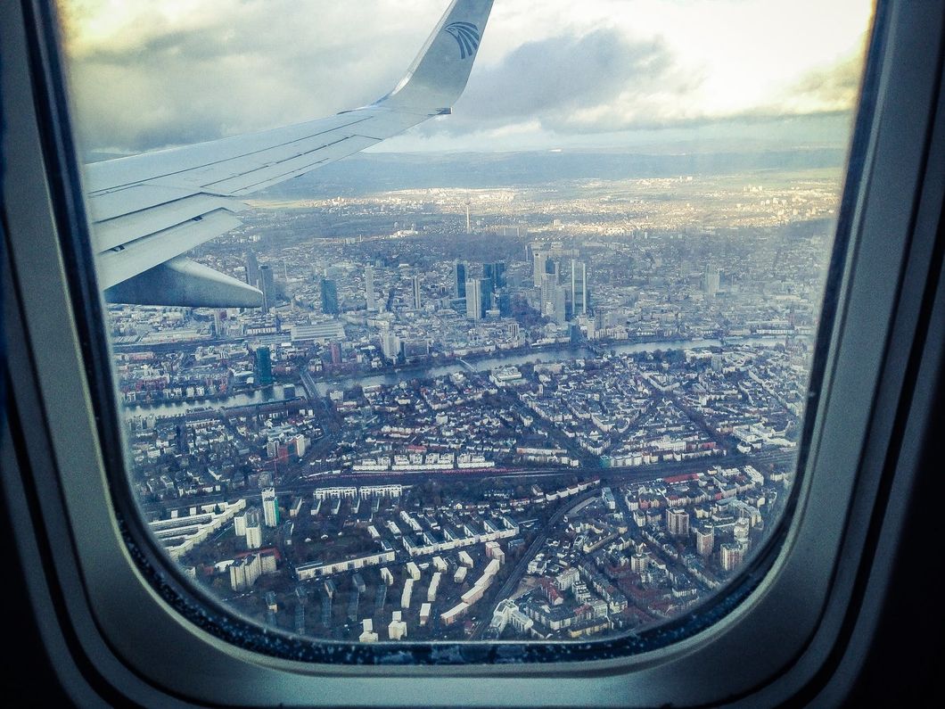 https://www.pexels.com/photo/airplane-windowpane-showing-city-buildings-316794/