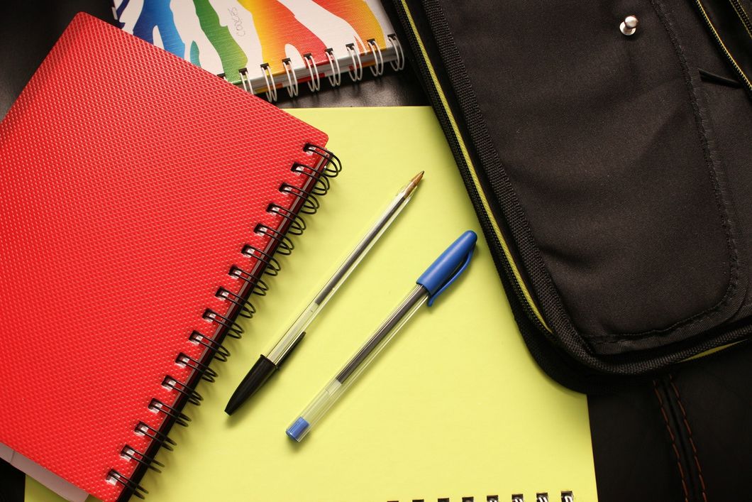 https://www.pexels.com/photo/black-and-blue-pens-beside-red-covered-notebook-159497/