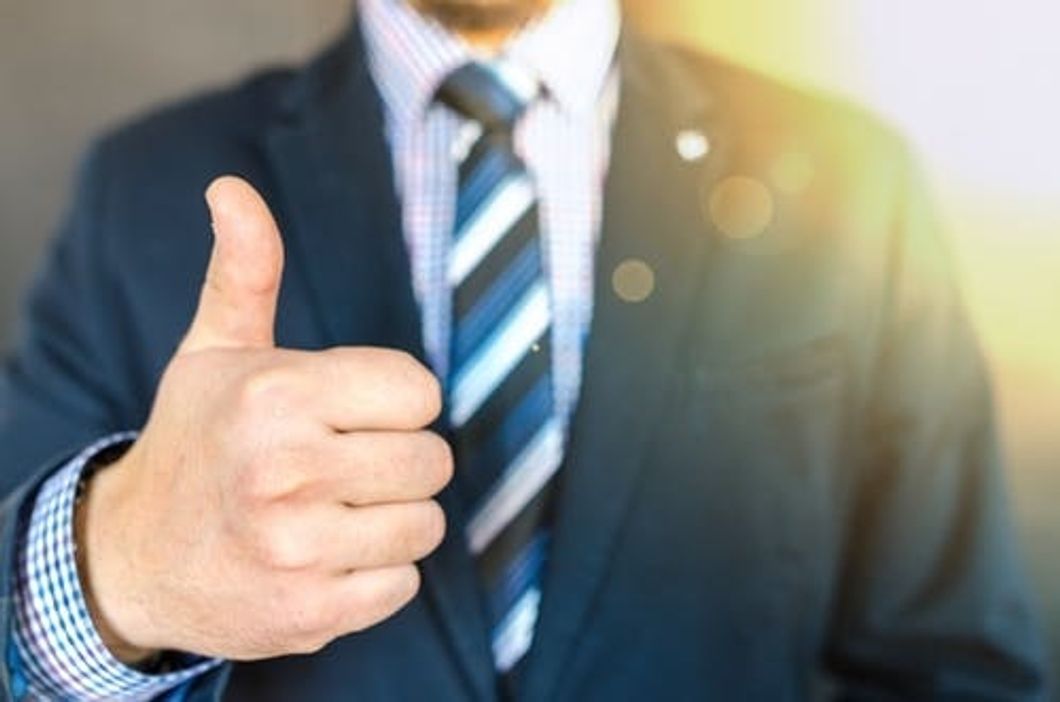 https://www.pexels.com/photo/close-up-photo-of-man-wearing-black-suit-jacket-doing-thumbs-up-gesture-684385/