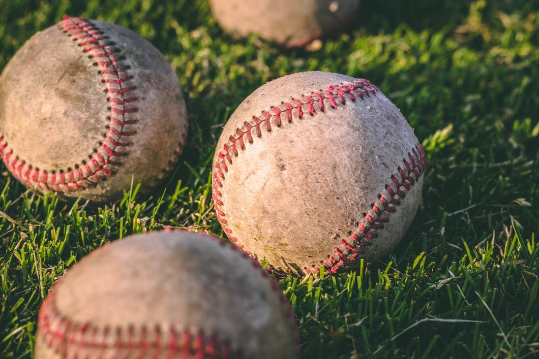 https://www.pexels.com/photo/close-up-photography-of-four-baseballs-on-green-lawn-grasses-1308713/
