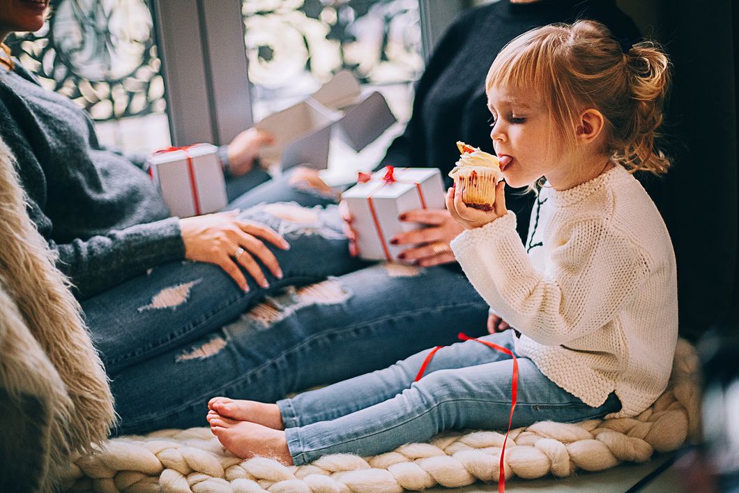 https://www.pexels.com/photo/girl-eating-cupcake-while-sitting-beside-woman-in-blue-denim-distressed-jeans-1261408/